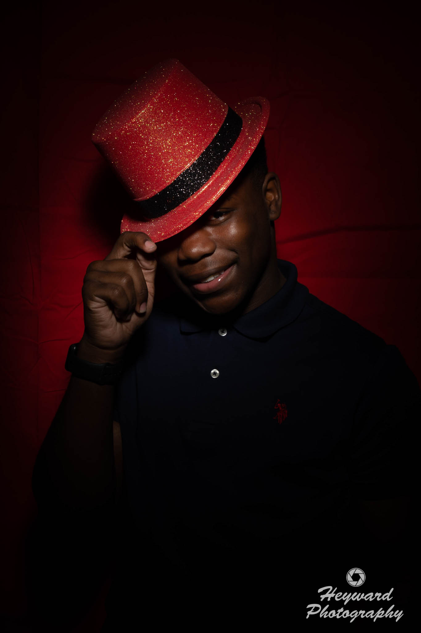 Black Male wearing a red hat.