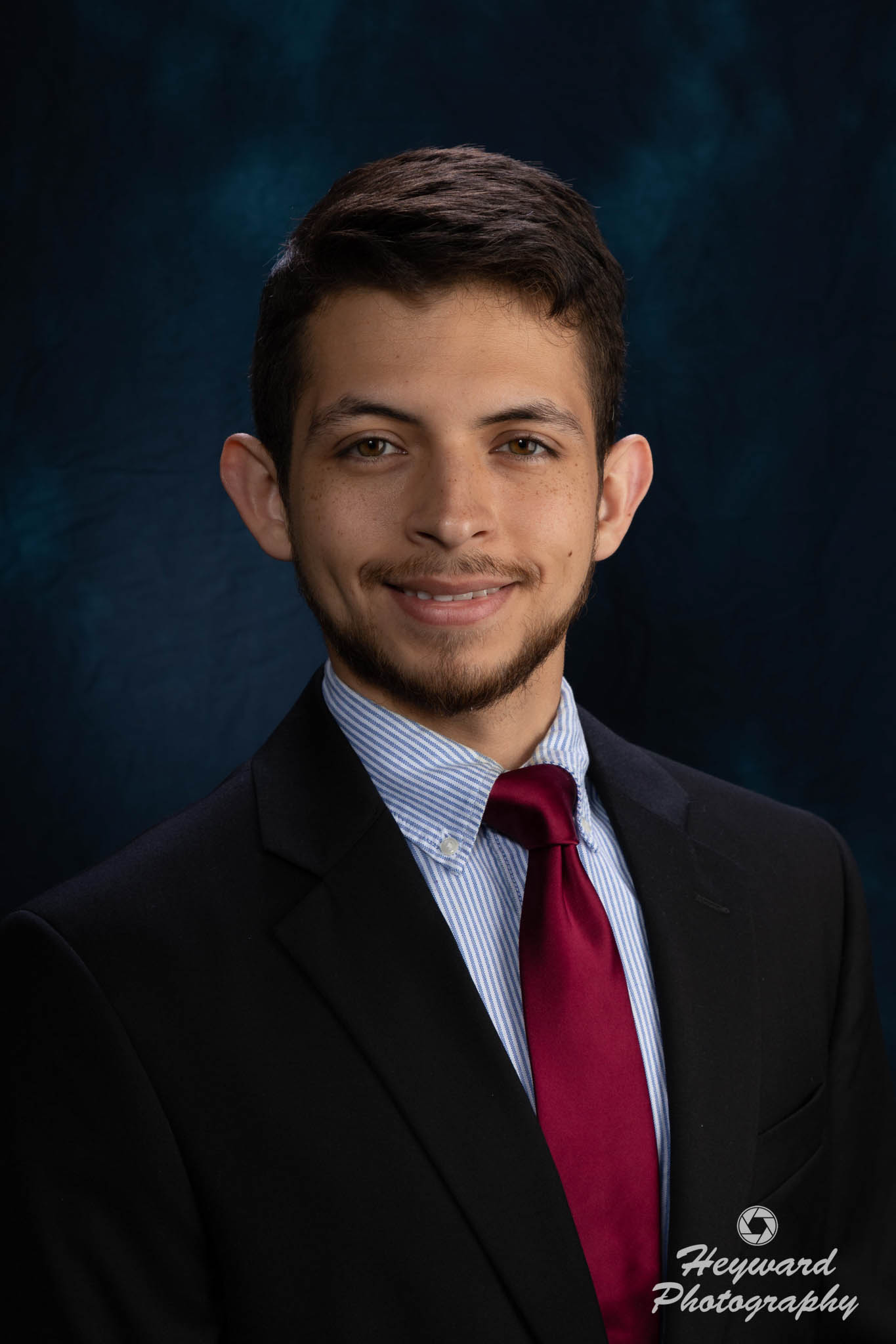 Latino man posing for a picture.